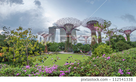 Futuristic aerial view of amazing illumination at Garden by the Bay day to night timelapse in Singapore. 112541338