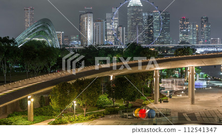 Aerial view with Singapore city skyline from Marina barrage garden night timelapse. 112541347