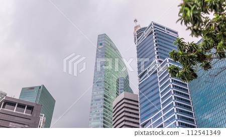Looking up perspective of modern business skyscrapers glass and sky view landscape of commercial building in central city timelapse Looking up perspective of modern business skyscrapers glass and sky view landscape of commercial building in central city timelapse 112541349