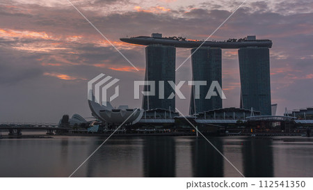 Sunrise near Marina Bay Sands Hotel dominates the skyline at Marina Bay in Singapore timelapse. 112541350