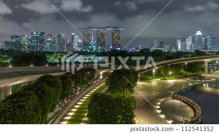Aerial view Singapore city skyline with colorful fountain at Marina barrage garden night timelapse hyperlapse. 112541352