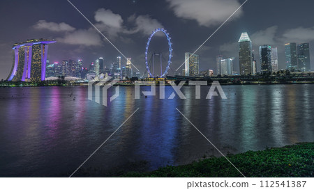 Downtown skyline of Singapore as viewed from across the water from The Garden East night timelapse. Singapore. 112541387