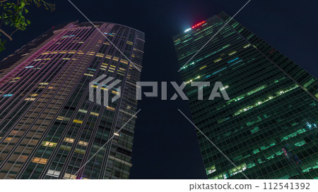 Looking up perspective of modern business skyscrapers glass and sky view landscape of commercial building in central city timelapse Looking up perspective of modern business skyscrapers glass and sky view landscape of commercial building in central city timelapse 112541392