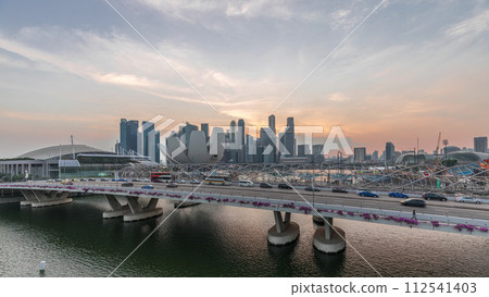 Aerial view over Helix Bridge and Bayfront Avenue with traffic day to night timelapse at Marina Bay, Singapore Aerial view over Helix Bridge and Bayfront Avenue with traffic day to night timelapse at Marina Bay, Singapore 112541403