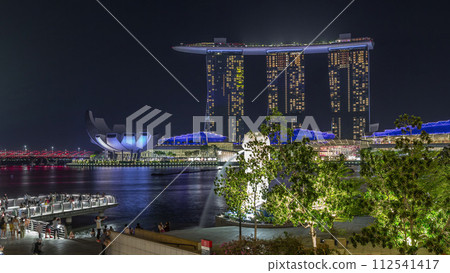 The Merlion fountain spouts water in front of the Marina Bay Sands hotel in Singapore timelapse hyperlapse. 112541417