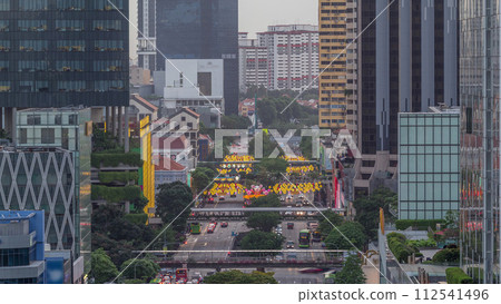 Traffic with cars on a street and urban scene in the central district of Singapore day to night timelapse Traffic with cars on a street and urban scene in the central district of Singapore day to night timelapse 112541496