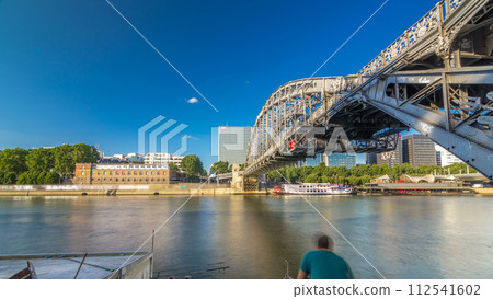 The Austerlitz viaduct in Paris timelapse hyperlapse, seen from bank of the river Seine with a metro train passing 112541602