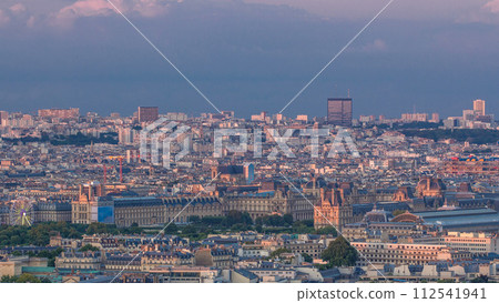 Aerial view of a large city skyline at sunset timelapse. Top view from the Eiffel tower. Paris, France. Aerial view of a large city skyline at sunset timelapse. Top view from the Eiffel tower. Paris, France. 112541941