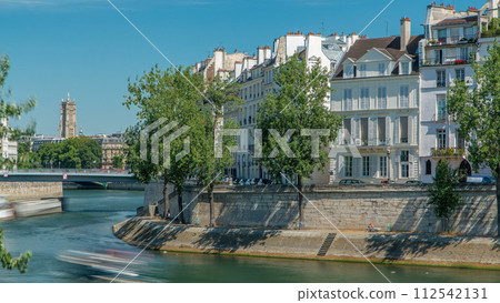 Saint-Louis bridge timelapse with houses on Orleans waterfront. Paris, France. Saint-Louis bridge timelapse with houses on Orleans waterfront. Paris, France. 112542131