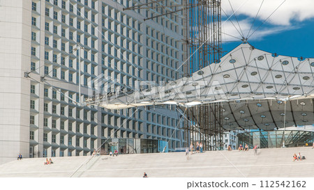 Close up view of Defence business district in Paris timelapse. People sitting on stairs during the day. Paris, France. Close up view of Defence business district in Paris timelapse. People sitting on stairs during the day. Paris, France. 112542162