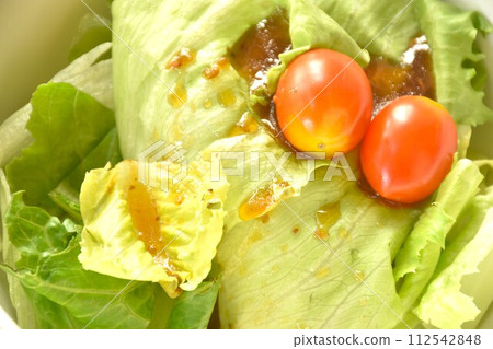 cos and tomato salad dressing Japanese sesame soy sauce on bowl cos and tomato salad dressing Japanese sesame soy sauce on bowl 112542848