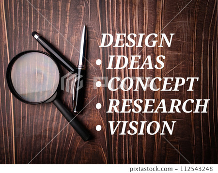 Top view magnifying glass and pen with text Design concept on wooden background. Top view magnifying glass and pen with text Design concept on wooden background. 112543248