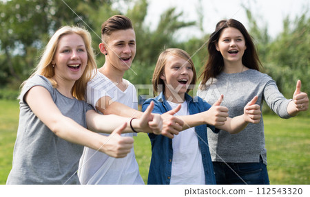 Teenagers show their thumbs up 112543320