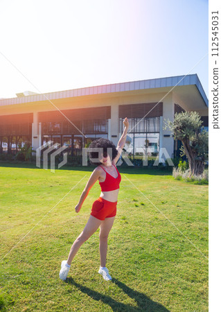 Woman doing sports exercises early in the morning 112545031