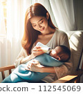 Mom feeding milk to baby 02 112545069