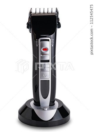 Closeup view of electric professional pet grooming clippers in charging base. Closeup view of electric professional pet grooming clippers in charging base. 112545475