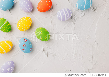 Easter Day Concept. Top view holiday banner background web design white colorful easter eggs painted on white cement background with empty copy space, celebration greeting card, overhead, template 112546941