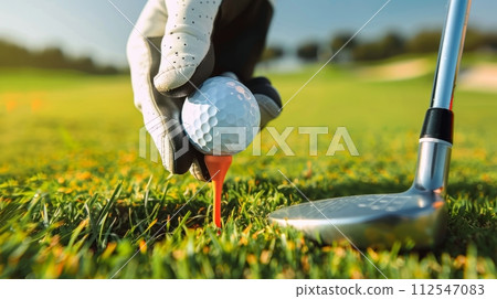 AI-generated content. Golfer in glove placing ball on tee with club head nearby, preparing to swing. Preparation for start of game. 112547083