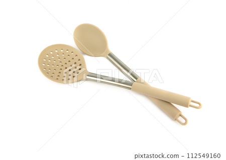 Kitchen slotted spoon and large spoon isolated on white . Kitchen slotted spoon and large spoon isolated on white . 112549160