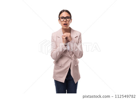 slim smart young woman with black hair and glasses for vision is dressed in a beige jacket and jeans slim smart young woman with black hair and glasses for vision is dressed in a beige jacket and jeans 112549782