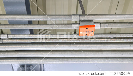 Steel Tube Fitting, Electricity and signal wire tubes attached on wall and ceiling, loft design or concept. Tube for fa, nps, cctv, ltg, pds, tel, cass cable. 112550009