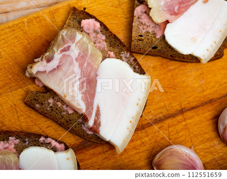 Snack for vodka, homemade salo with bread and horseradish Snack for vodka, homemade salo with bread and horseradish 112551659
