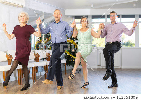Group of men and women dancing folk dance Group of men and women dancing folk dance 112551809