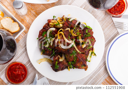 Pork shashlik with onion, greenery and glasses of wine Pork shashlik with onion, greenery and glasses of wine 112551908