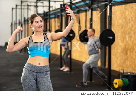 Young woman taking selfie at gym 112552077