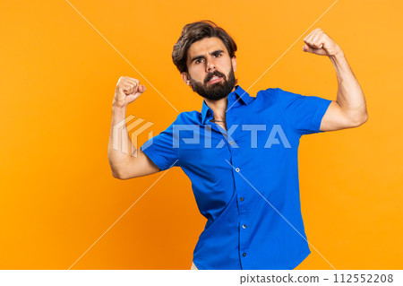 Man showing biceps and looking confident, feeling power strength to fight for rights, success win 112552208