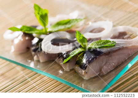 Marinated herring with sliced onion Marinated herring with sliced onion 112552223