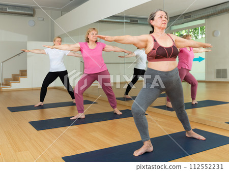 Group of active mature women practicing yoga 112552231