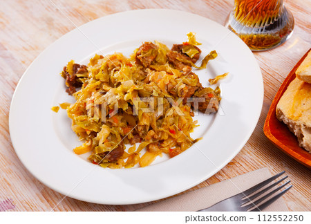 Appetizing cabbage stewed with pork meat on white plate Appetizing cabbage stewed with pork meat on white plate 112552250