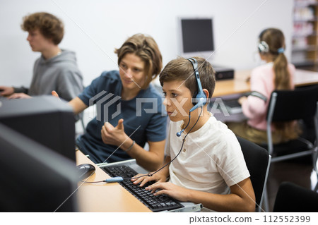 Schoolboy and schoolgirl working with computers in class room 112552399