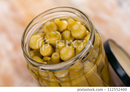 Pile of pickled okra in opened glass jar Pile of pickled okra in opened glass jar 112552400