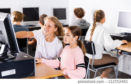 Young boys and girls using computers in classroom Young boys and girls using computers in classroom 112552401