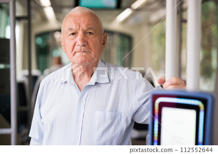 Senior European man in tram Senior European man in tram 112552644
