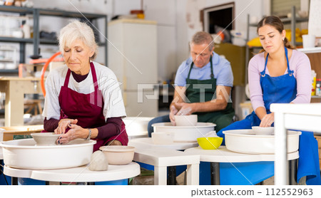 lady works on potter's wheel lady works on potter's wheel 112552963