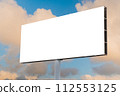 Blank white billboard against the warm sunset sky with clouds - mock up 112553125