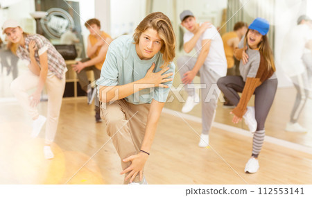 Teens performing modern dance in studio 112553141