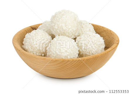 round candy raffaello with coconut flakes and nut in wooden bowl isolated on white background 112553353