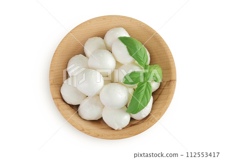 Mini mozzarella balls with basil in a wooden bowl isolated on white background. Top view. Flat lay. 112553417