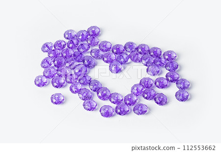 Purple acrylic beads on a white background 112553662