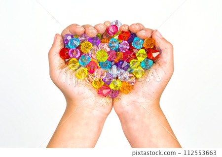 children's hands, hands holding beads on a white background 112553663