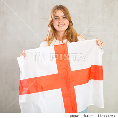 Portrait of positive young girl holding England flag Portrait of positive young girl holding England flag 112553863