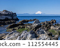 Snow-covered Mt. Fuji from the rugged rocky Jogashima Island 112554445