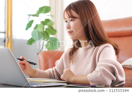 Woman working on a personal computer Woman working on a personal computer 112555394