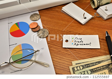 A desk with a card that says free trade agreement A desk with a card that says free trade agreement 112555697
