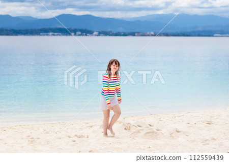 Kids playing on beach. Children play at sea. 112559439