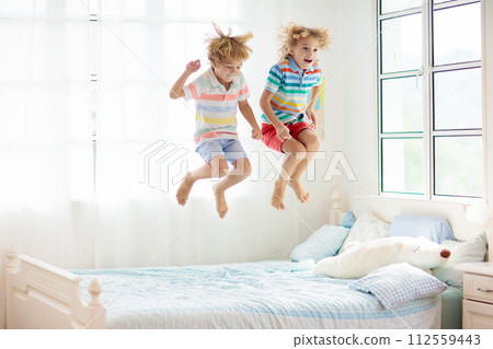 Child playing in bed. Kids room. Boy at home. 112559443